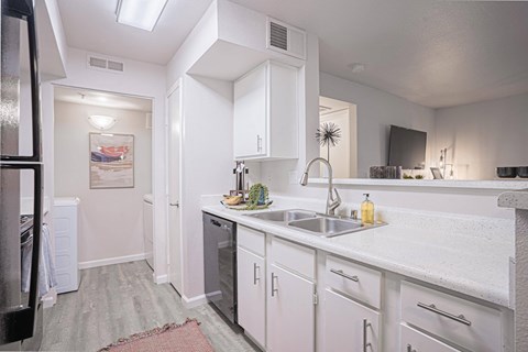a kitchen with white cabinets and a stainless steel sink at Austin Crest Apartments, Nevada